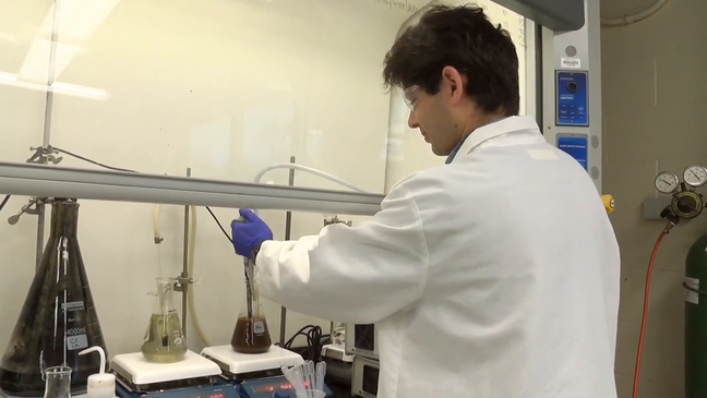 "Younes Hekarian, a PhD Student, works with some samples of cobalt and manganese. (WJAC)"